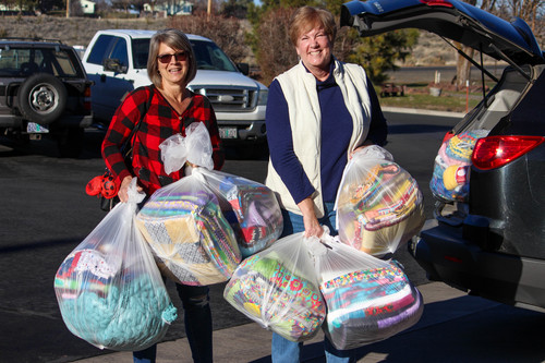 Suzy Field and Susan Oates of Project Linus deliver bags of handmade blankets to the Klamath County School District.