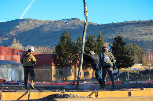 Workers pour concrete for the foundation of the new Shasta Elementary School classroom addition