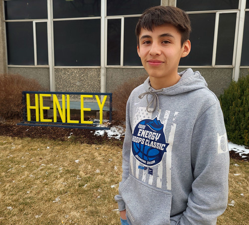 Image of Kai Crume in front of Henley sign.