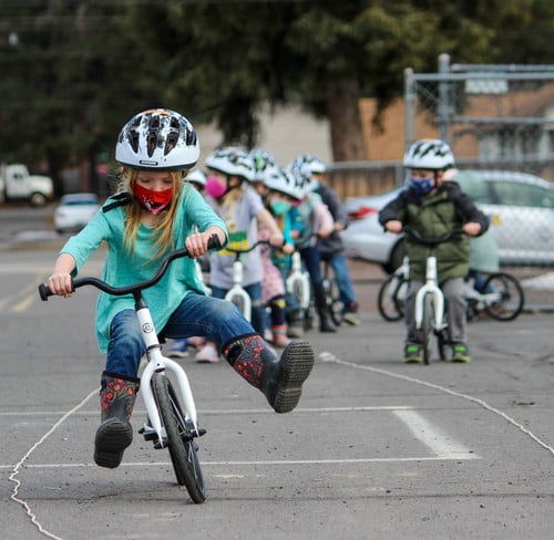 Girl riding a strider bike