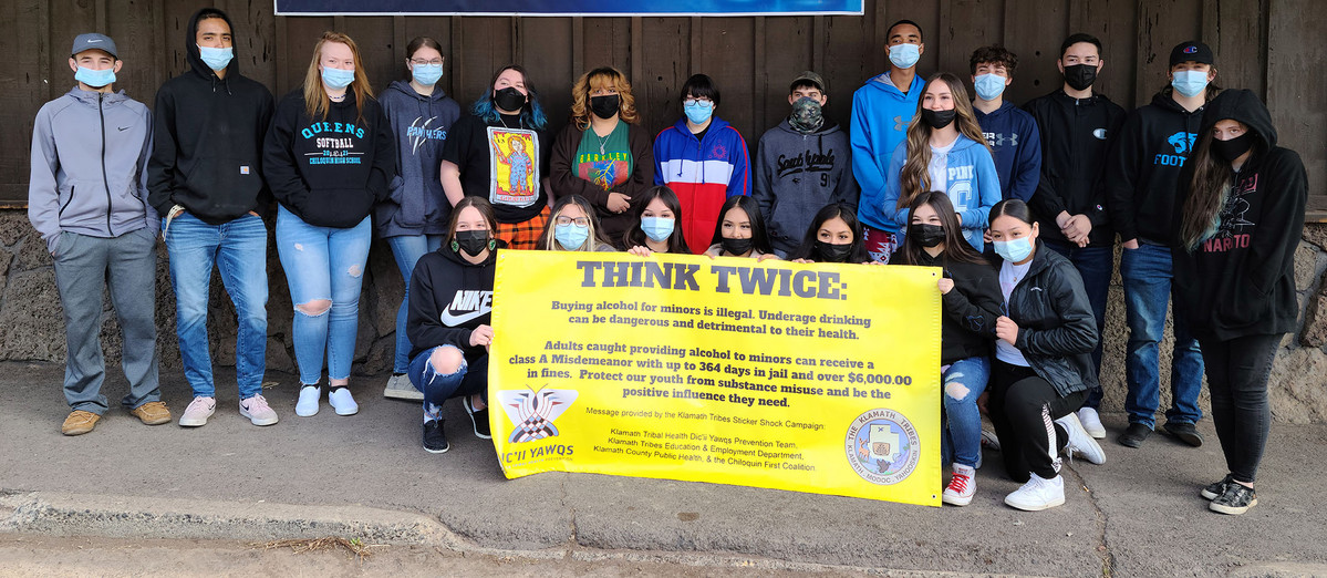 Students pose with Think Twice sign