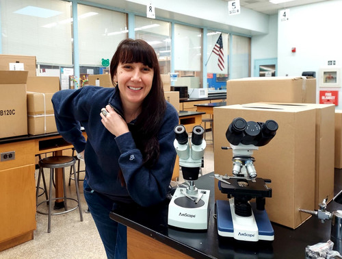 Teacher with two new microscopes