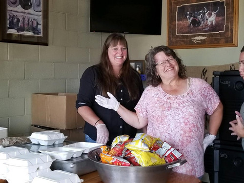 Nutrition Service Staff serving lunch to community